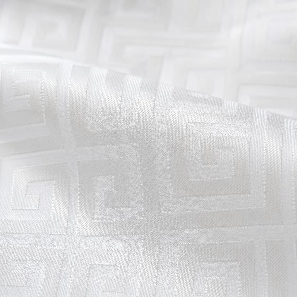 Wavy folds of white jacquard fabric