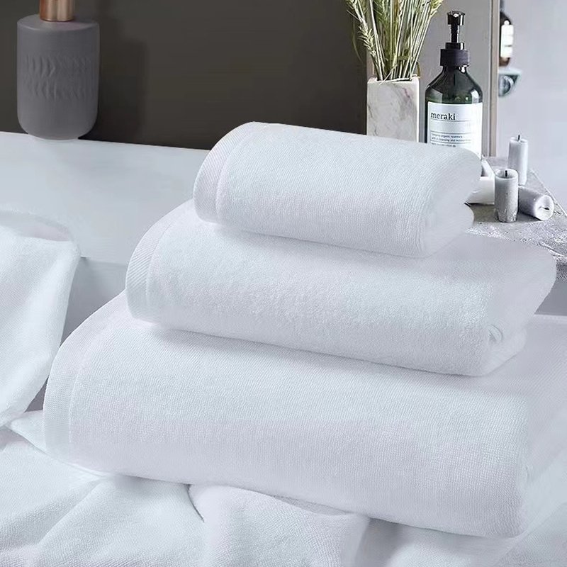 Folded white hotel towels ready for dispatch