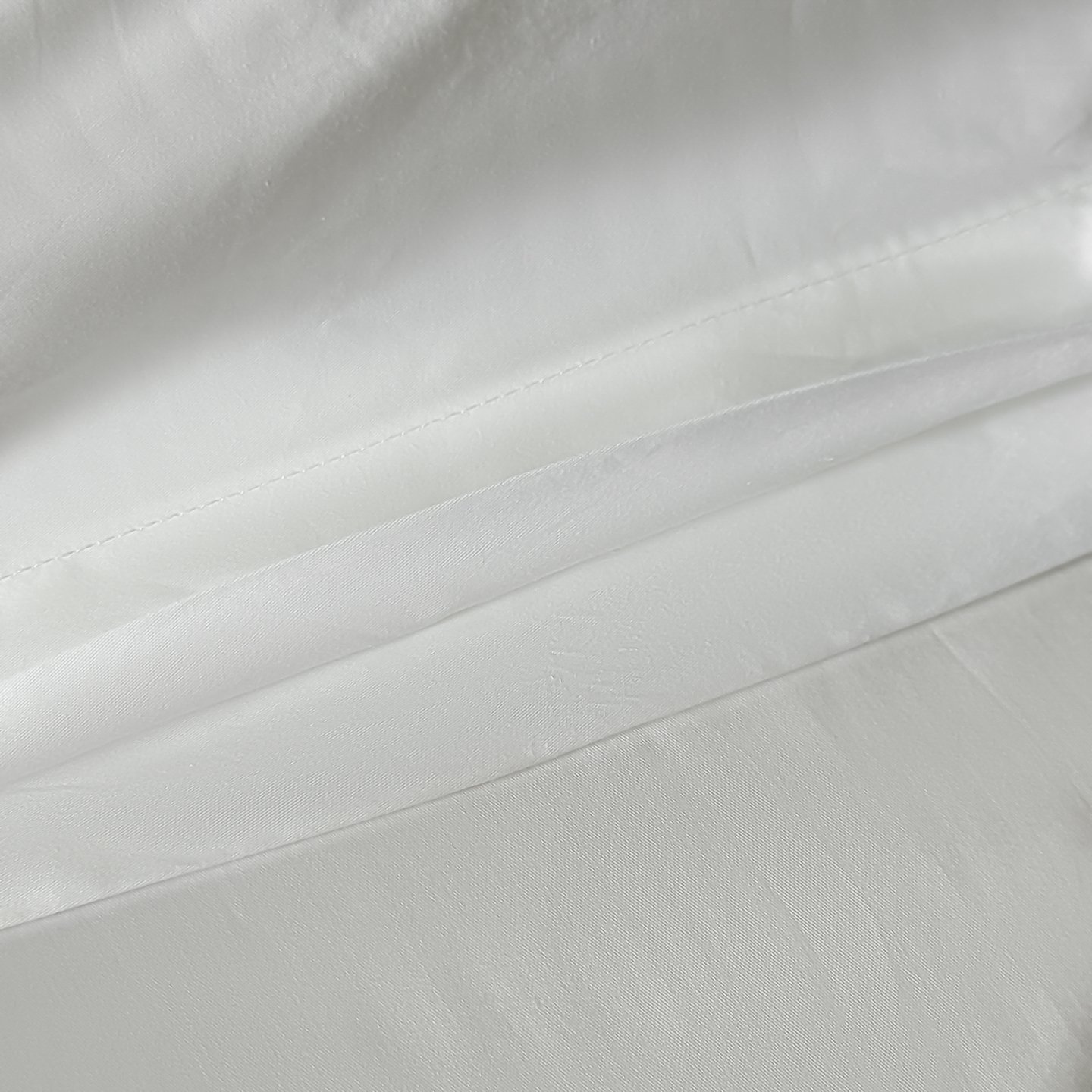 Stacked smooth white hotel fabrics